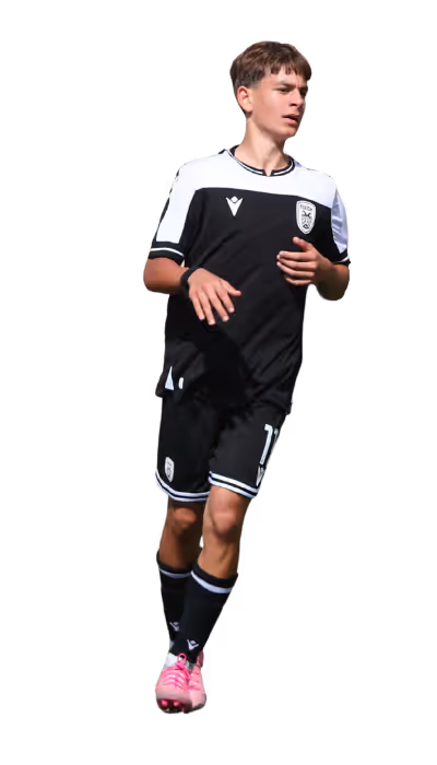 Soccer player wearing black and white uniform with pink cleats running.