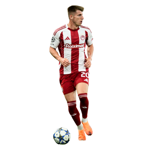 Soccer player in red and white kit running towards a ball.