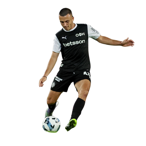 Soccer player in black and white uniform kicking a ball.
