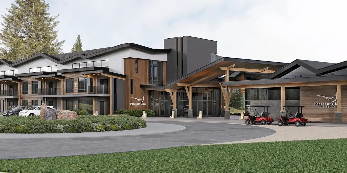 Modern resort building with wooden accents, a circular driveway, parked cars, and golf carts near the entrance.