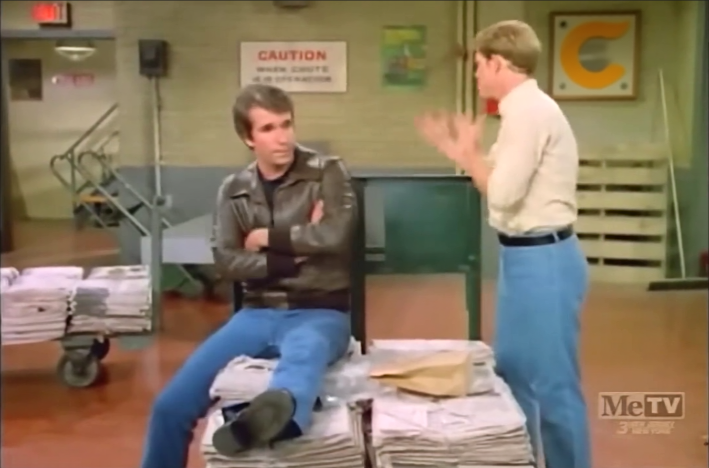 an image of two men in a warehouse talking to one another