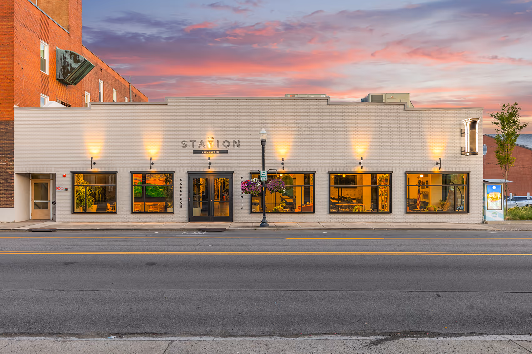 The front entrance of Station Gallatin on the outside during a sunset in the evening.
