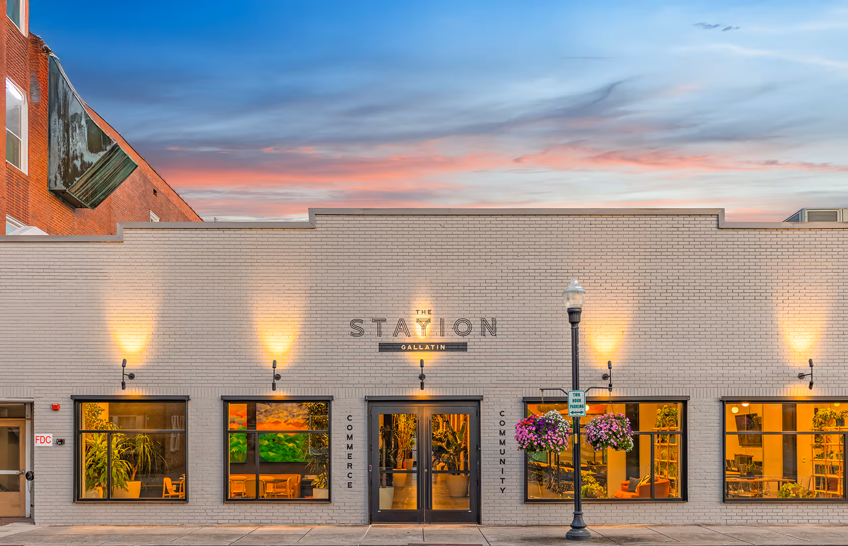The front entrance of Station Gallatin on the outside during a sunset in the evening.