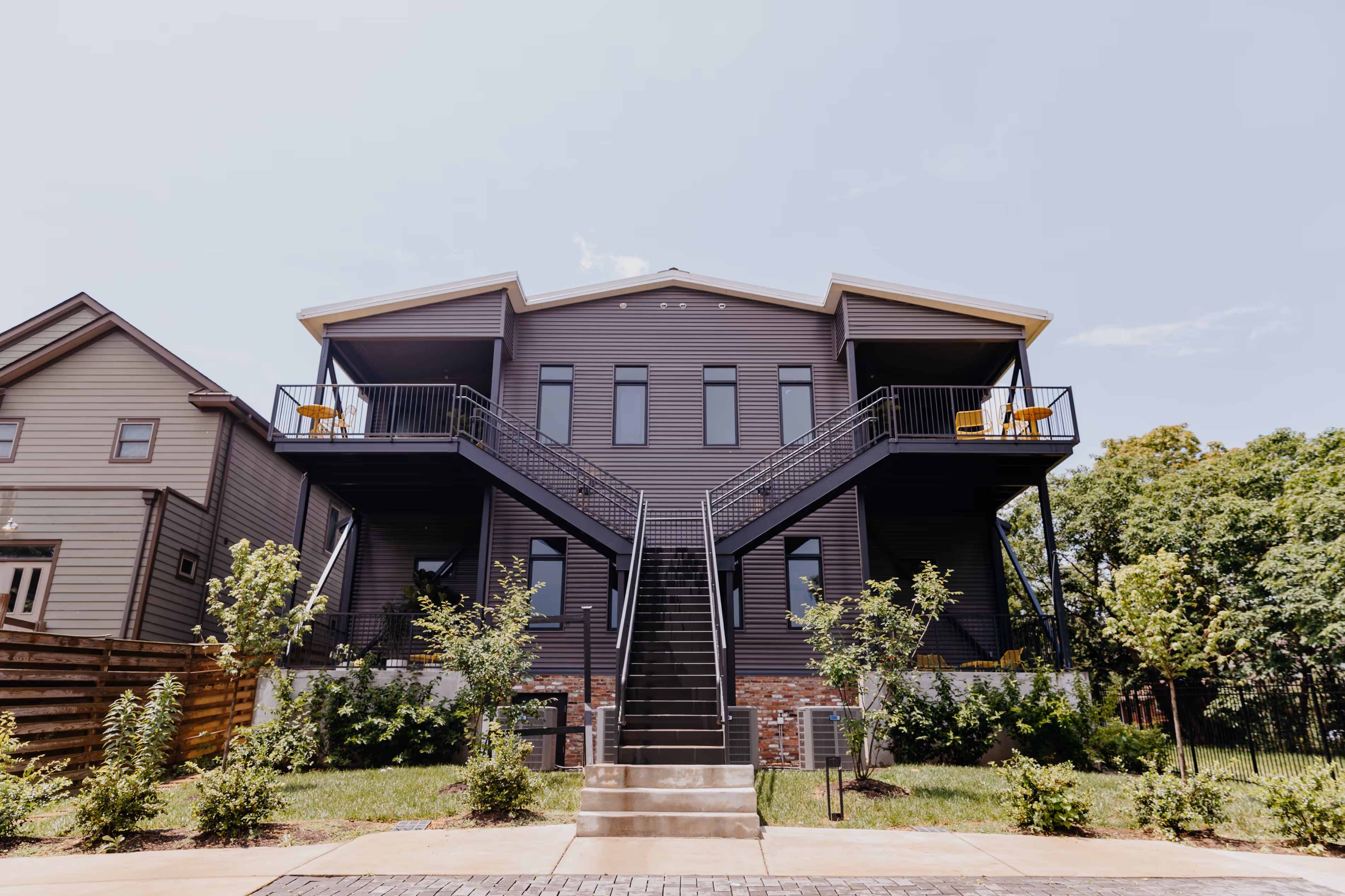 The back exterior of Sparrow, highlighting the staircases leading up to the upper residences.