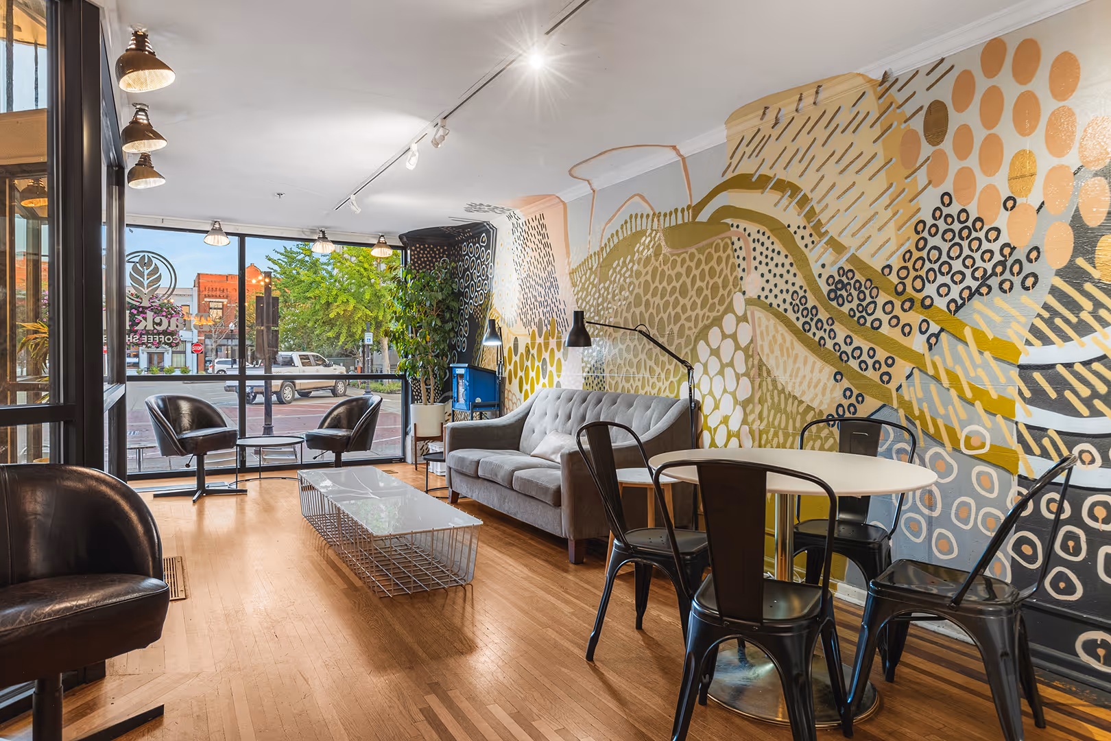 Seating area inside 106 Public Square with mural in the background.