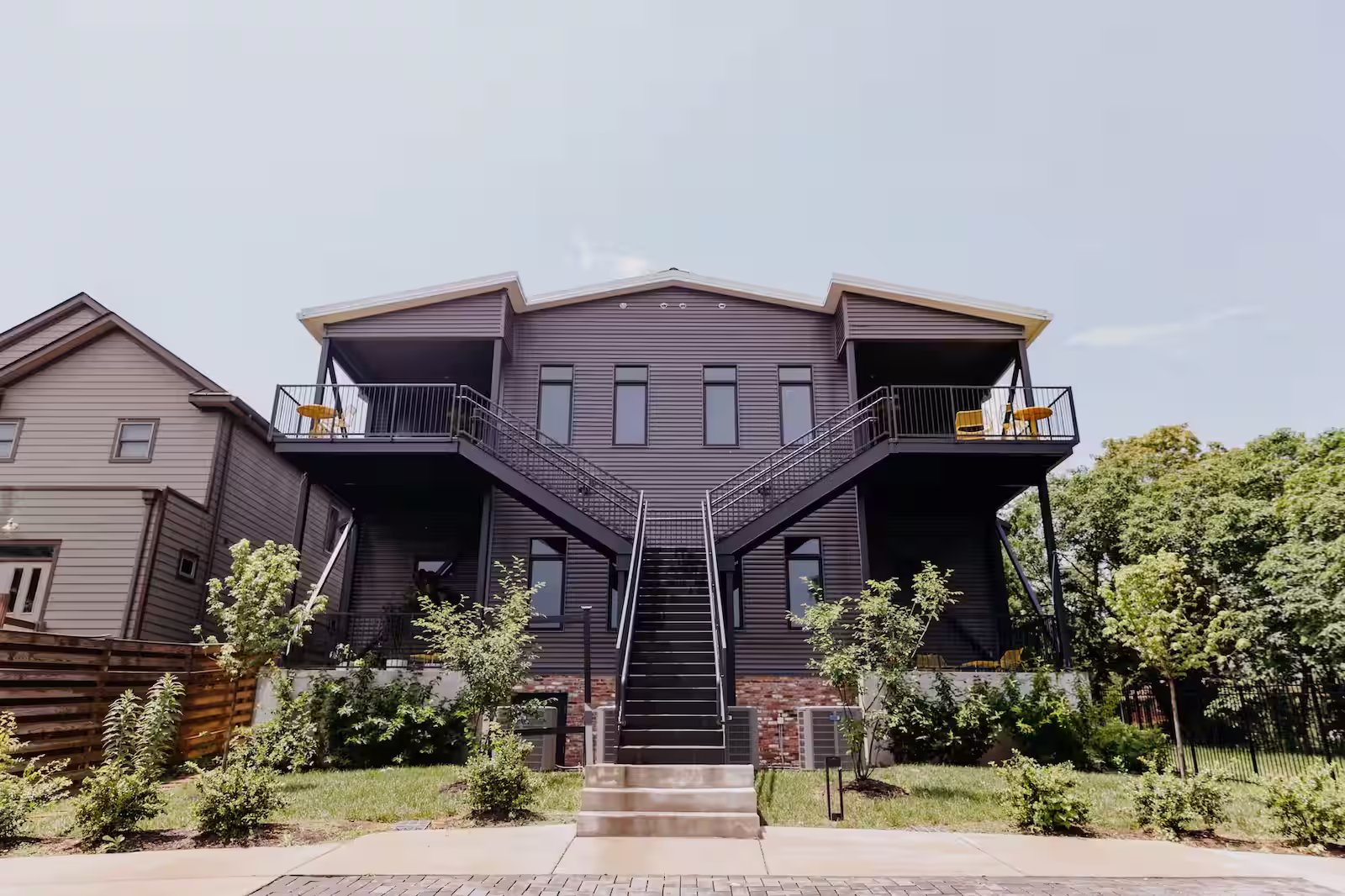 Back of a condominium complex showing two parallel staircases