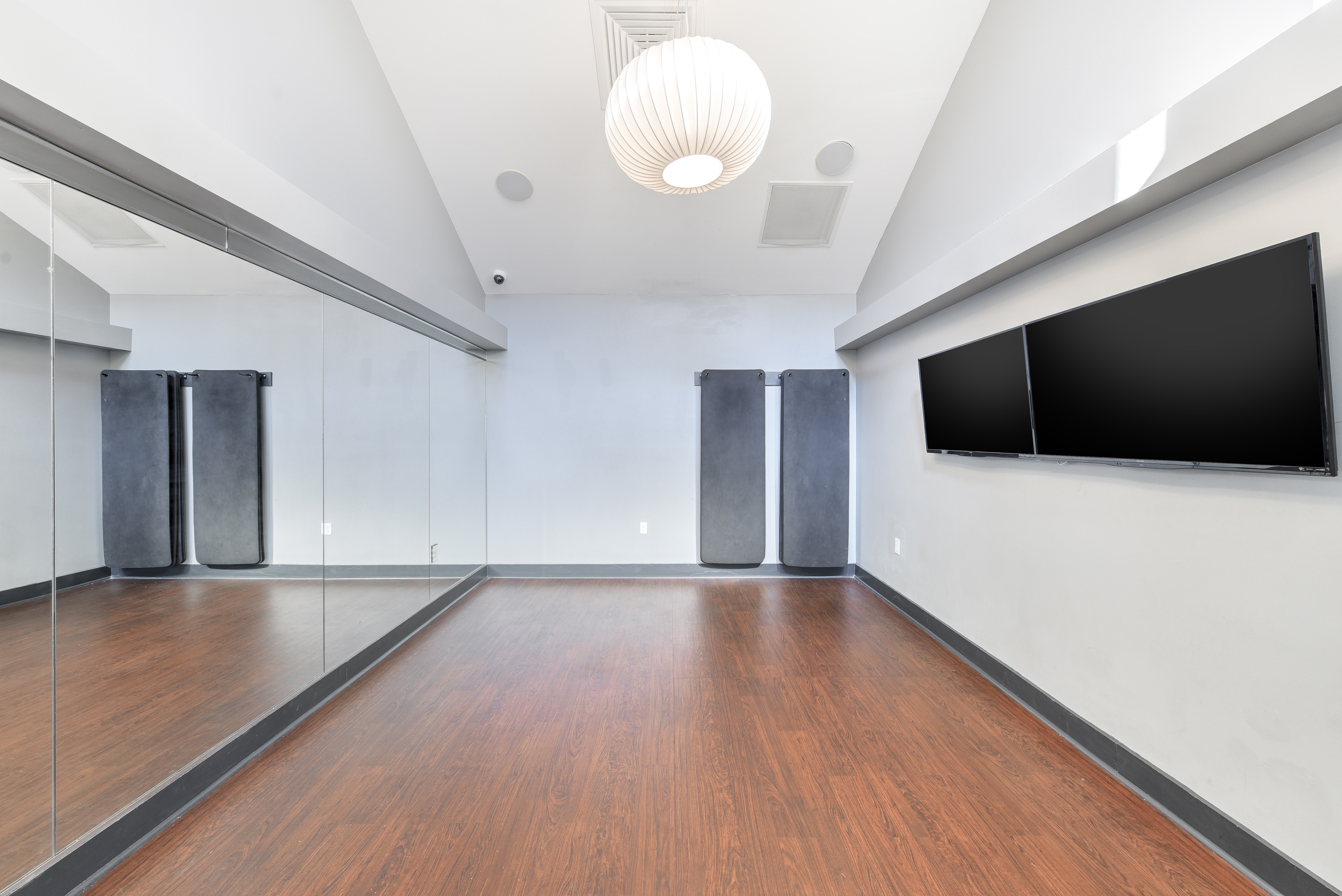 Yoga room with yoga mats and tv on the wall 