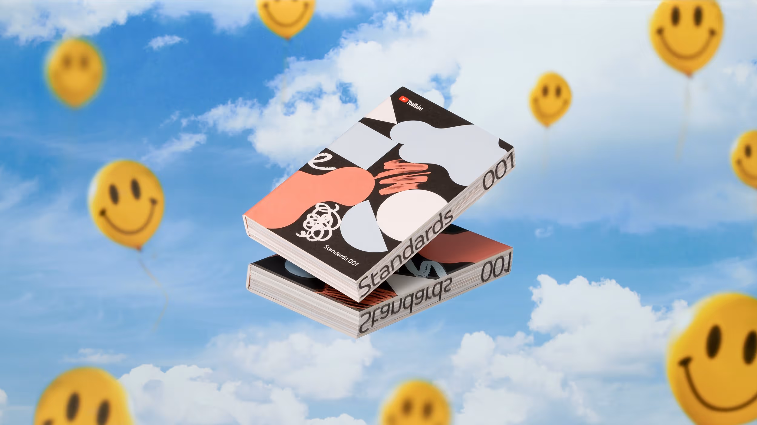 Two stacked books titled 'Standards 001' with abstract colorful covers floating against a blue sky with smiling yellow balloons.