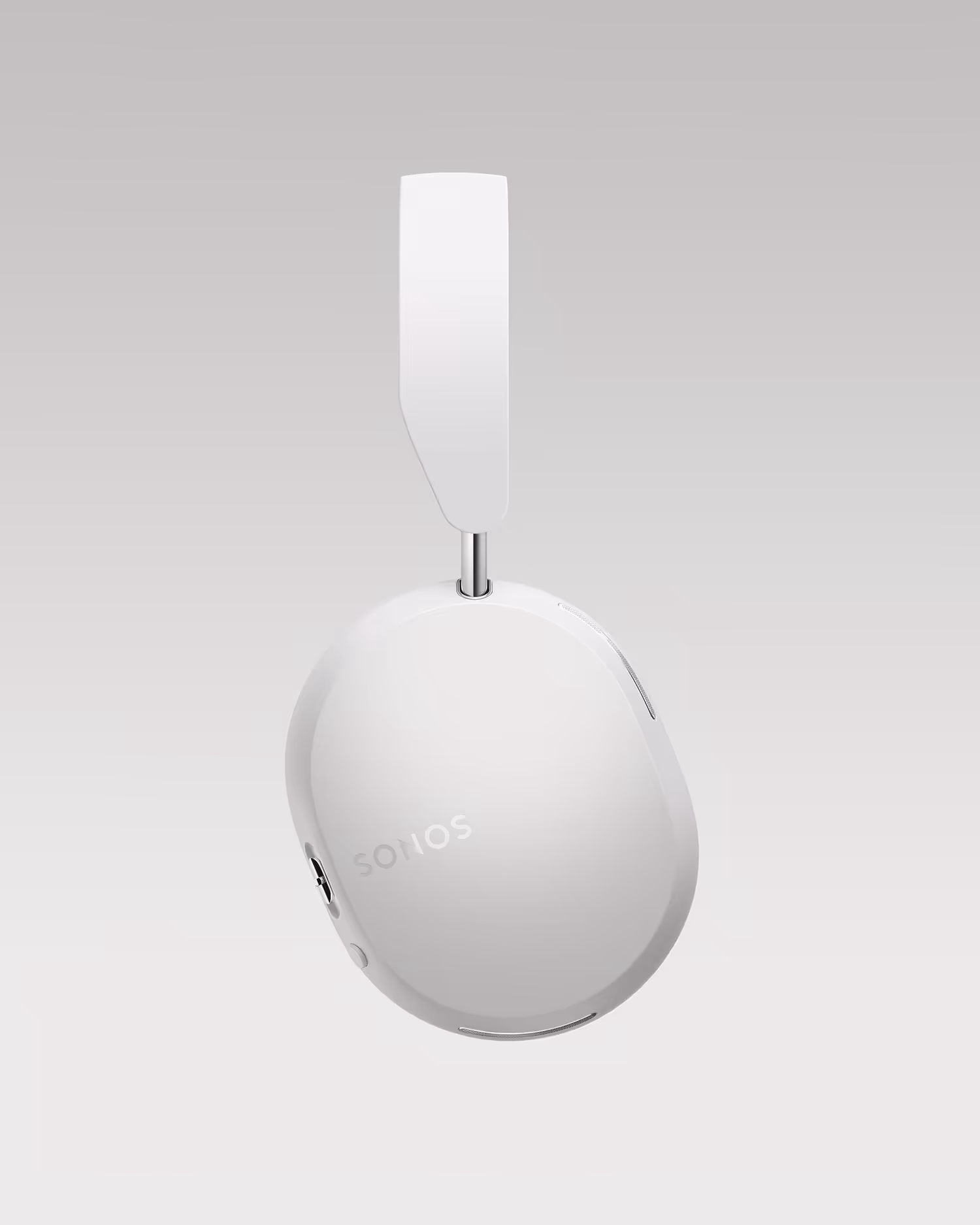 Close-up of a white Sonos headphone ear cup and part of the headband against a light gray background.
