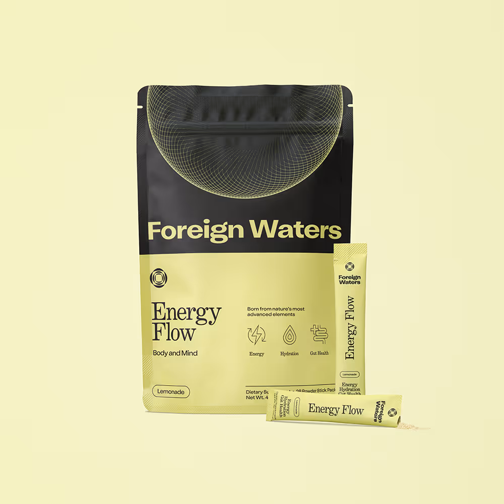Foreign Waters Energy Flow lemonade powder supplement packaging with two individual stick packs on a pale yellow background.
