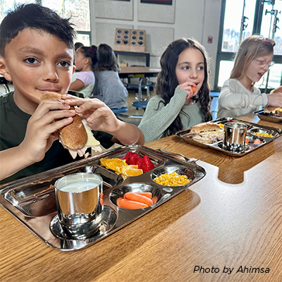 Students enjoying lunch in the reusable lunch plate at the cafeteria