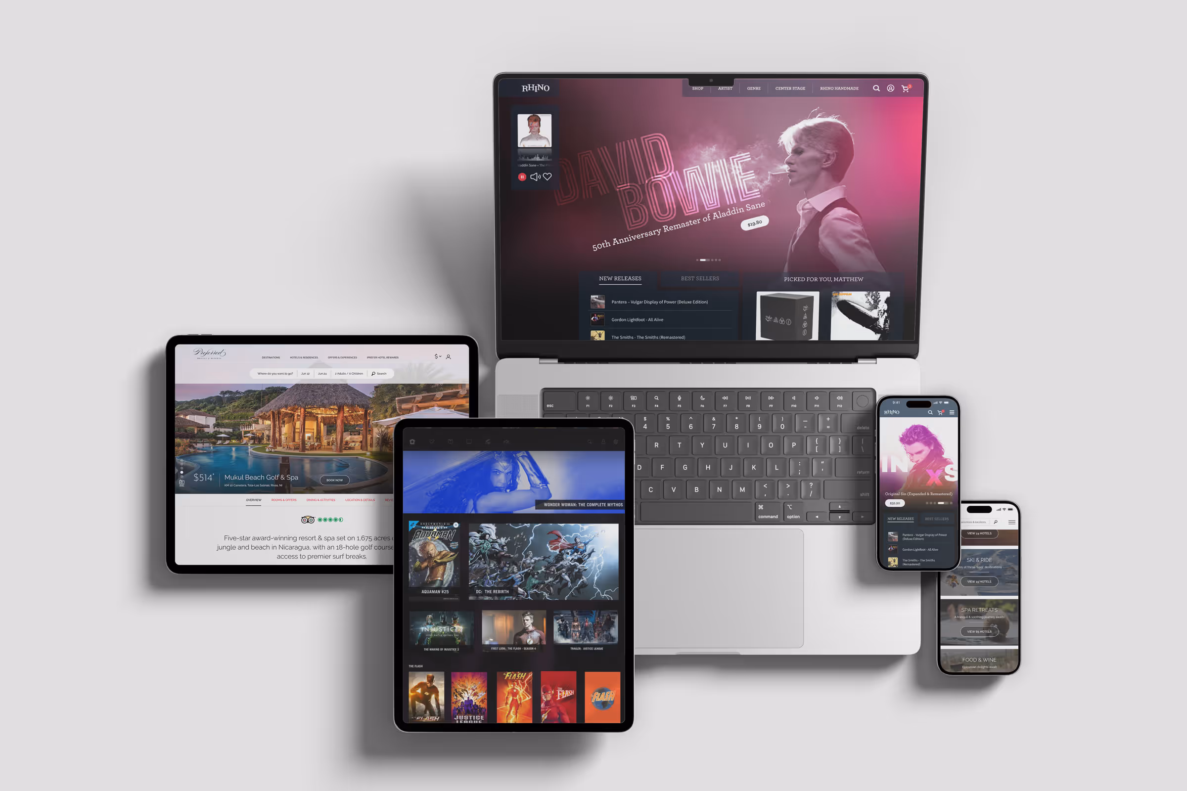 Laptop, two tablets, and two smartphones displaying different apps including music, travel booking, and streaming services on a white background.