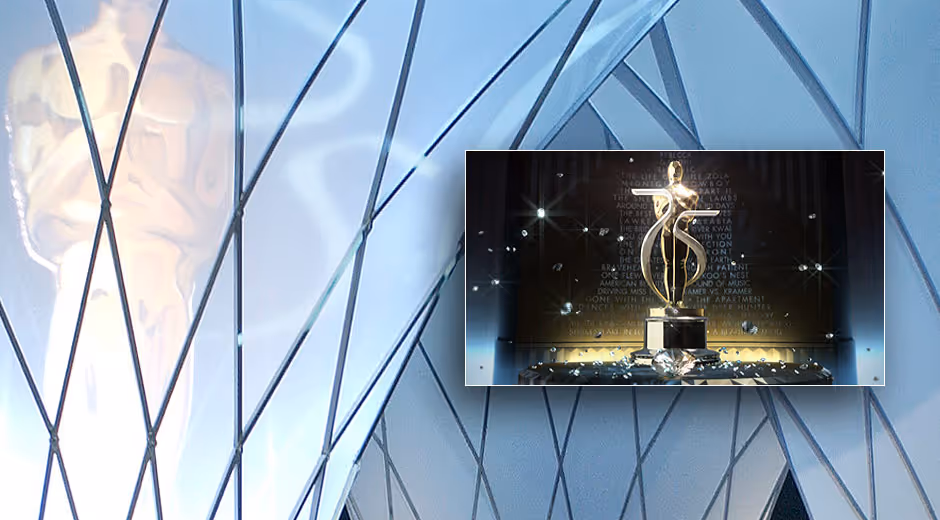 Golden statuette on a pedestal surrounded by sparkling fragments in front of a wall with engraved text. Screenshots from the 75th Oscars telecast
