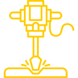 Yellow line icon of a jackhammer breaking the ground.