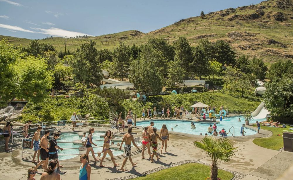 image of park with people enjoying rides