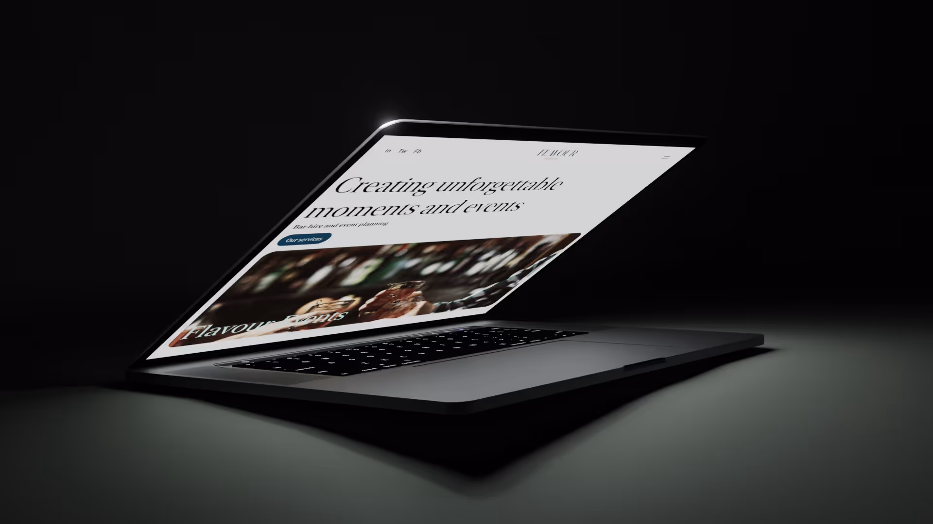 Laptop displaying Andrew James home page with modern kitchen.