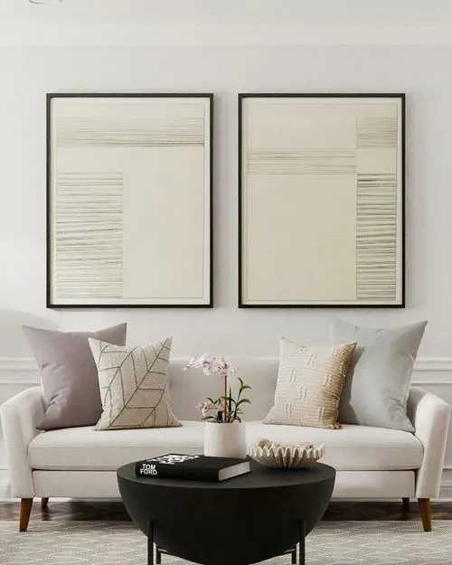 Two pieces of art above sofa