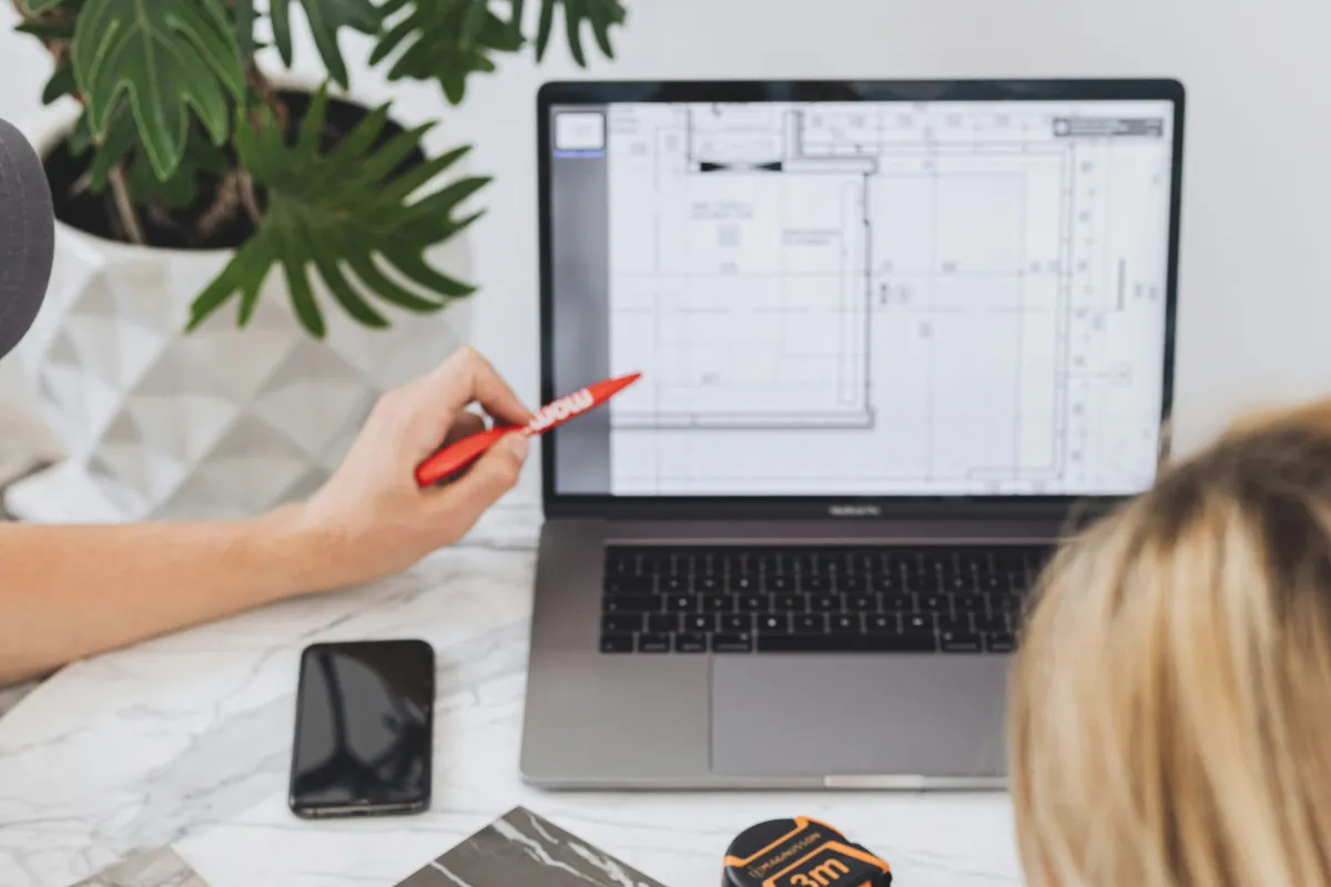 Two designers working on specs and looking at computer