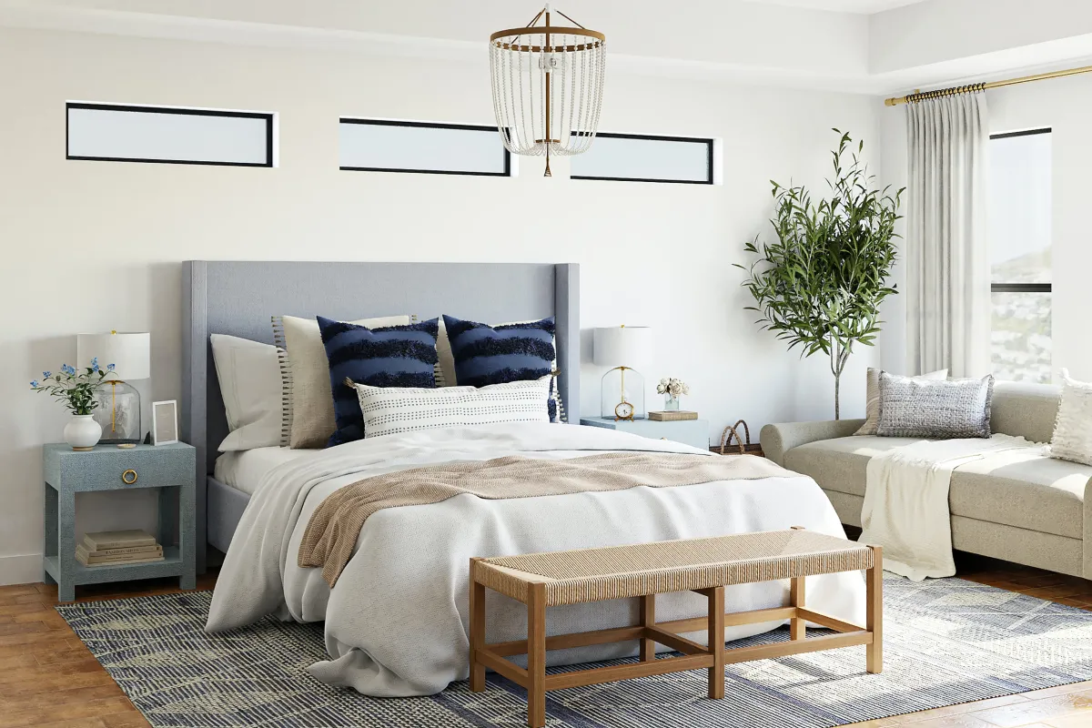 Large bed with chandelier above in bright room