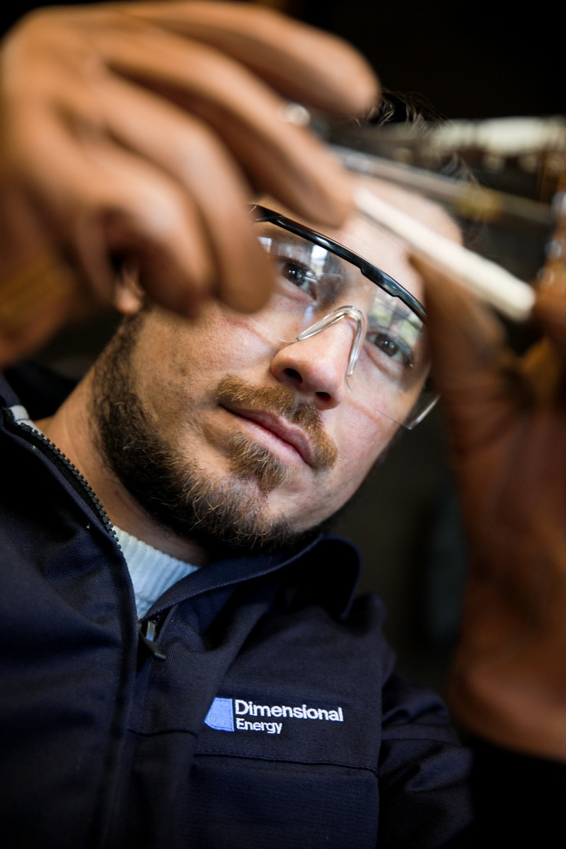 A Dimensional Energy employee analyses a sample.