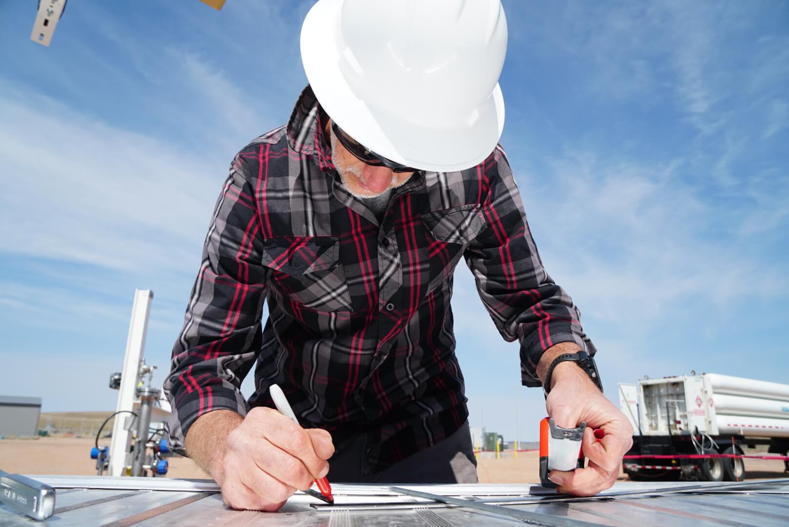 Jason Salfi makes notes on a plan.