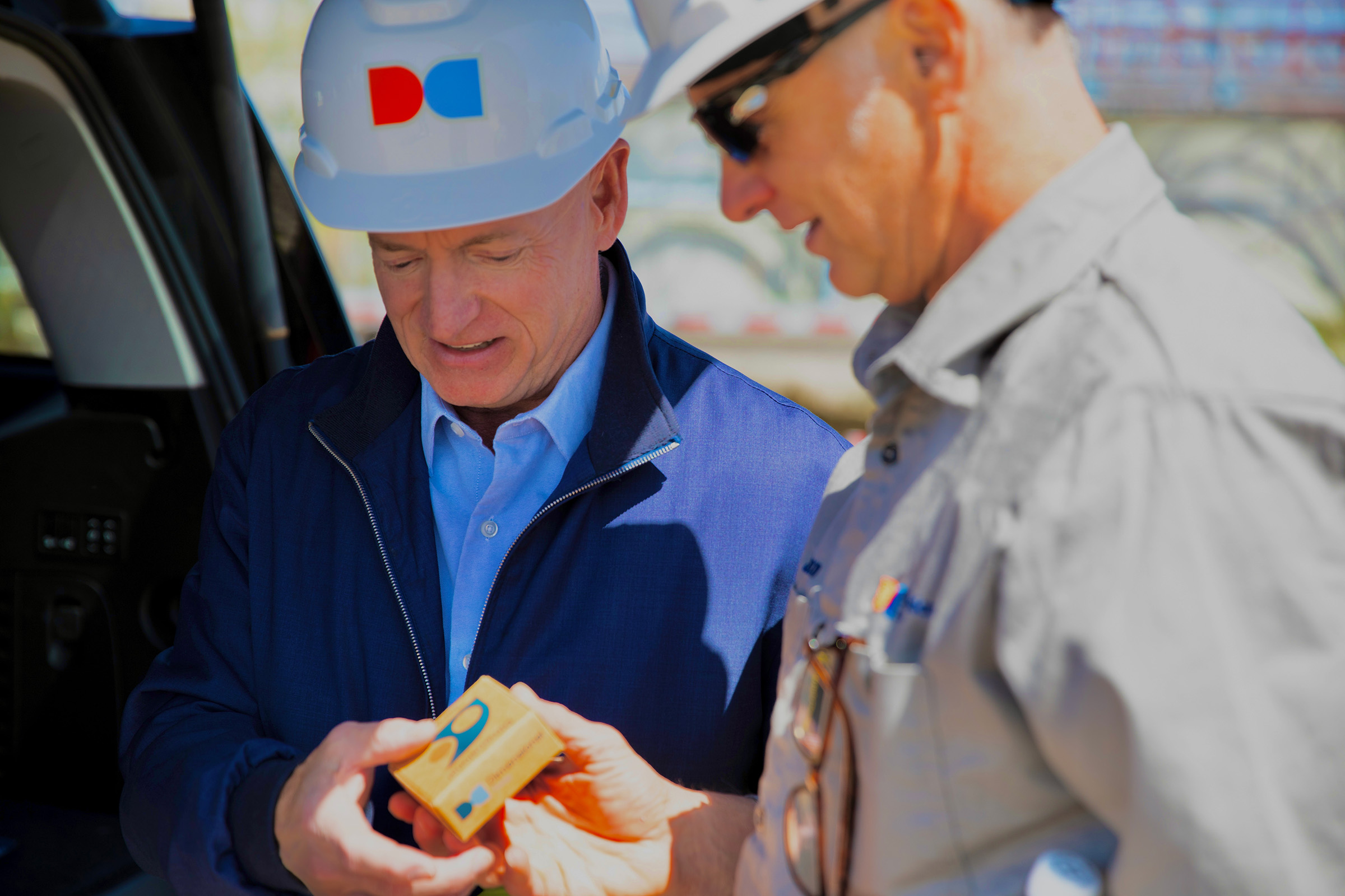 Senator Kelly and Jason admire samples of our Dimensional Energy Surf Wax.