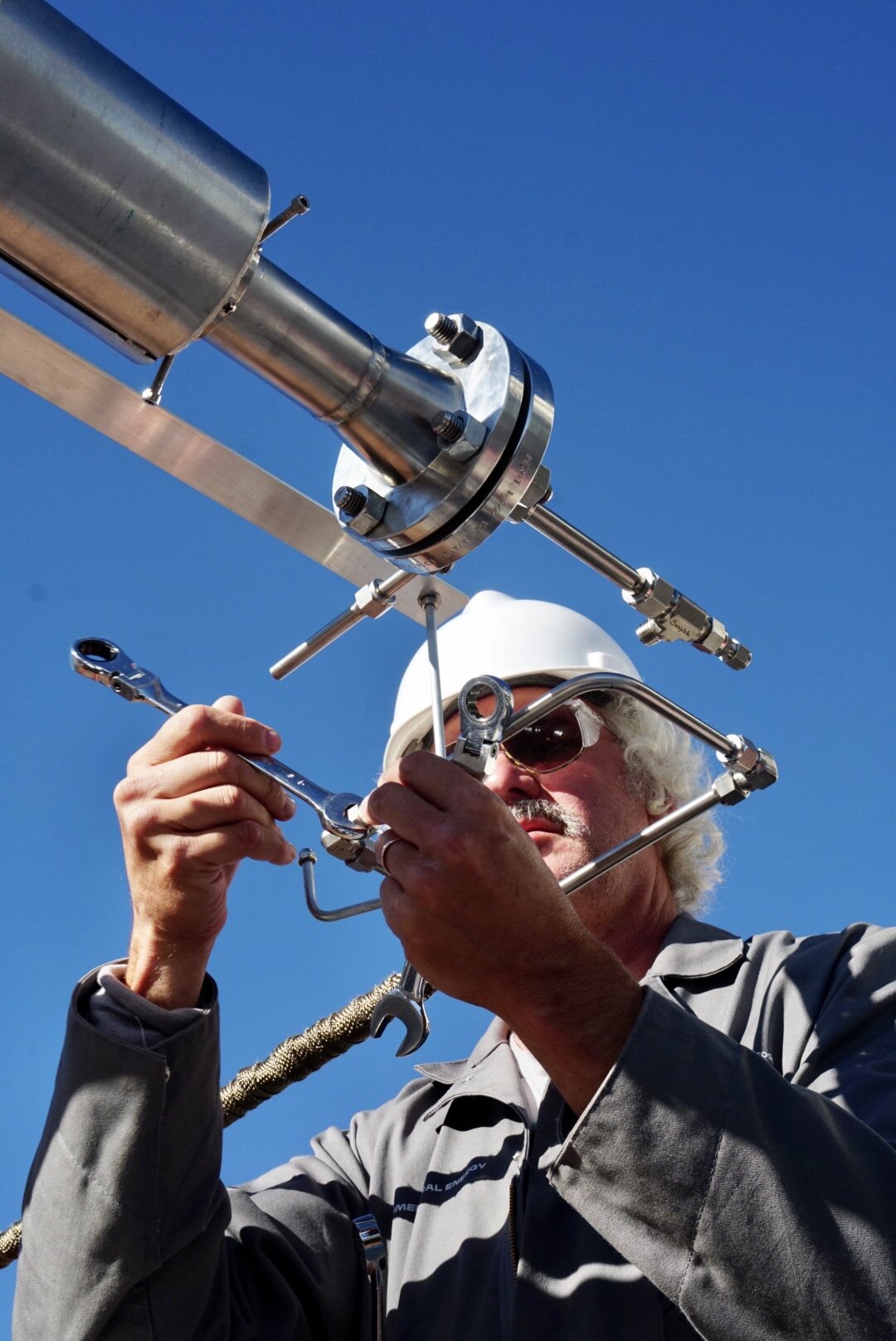 Brian connects the gas line to the reactor. At long last, the entire system is ready for testing.