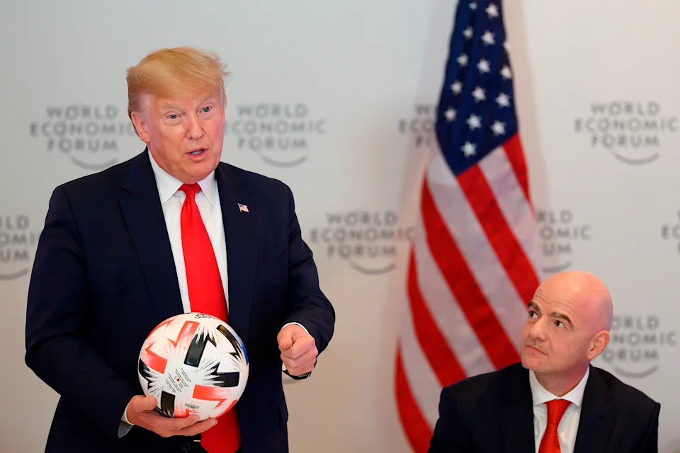 US President Donald Trump (L) holds a football as he speaks with FIFA President Gianni Infantino during the Global Chief Executive Officers dinner at the World Economic Forum in Davos, Switzerland, on January 21, 2020. (Photo by JIM WATSON / AFP) (Photo by JIM WATSON/AFP via Getty Images)