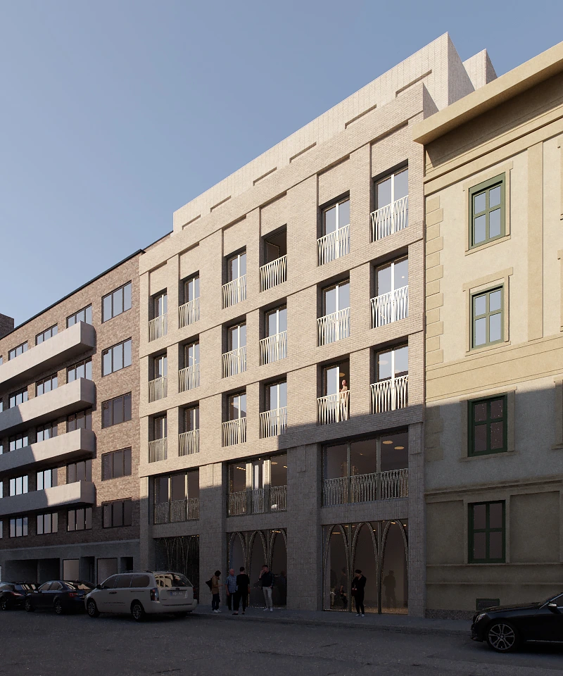 Street view of modern multi-story residential buildings with balconies and people standing near the entrance under a clear blue sky.