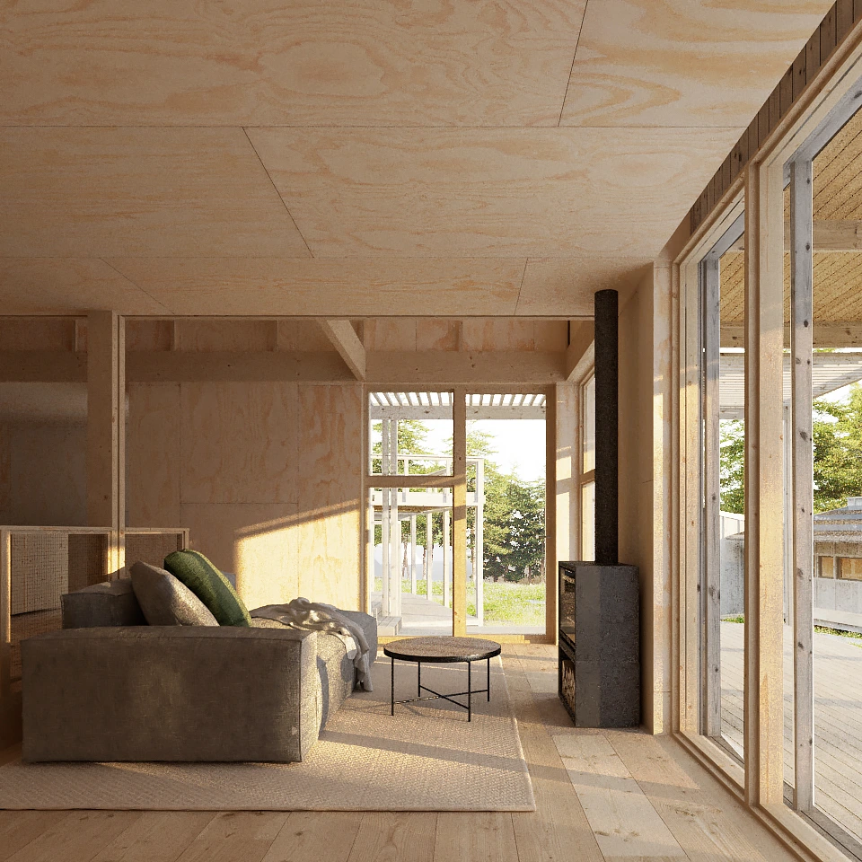 Cozy living room with a gray sofa, green and gray cushions, round coffee table, and a black wood stove beside large glass sliding doors.