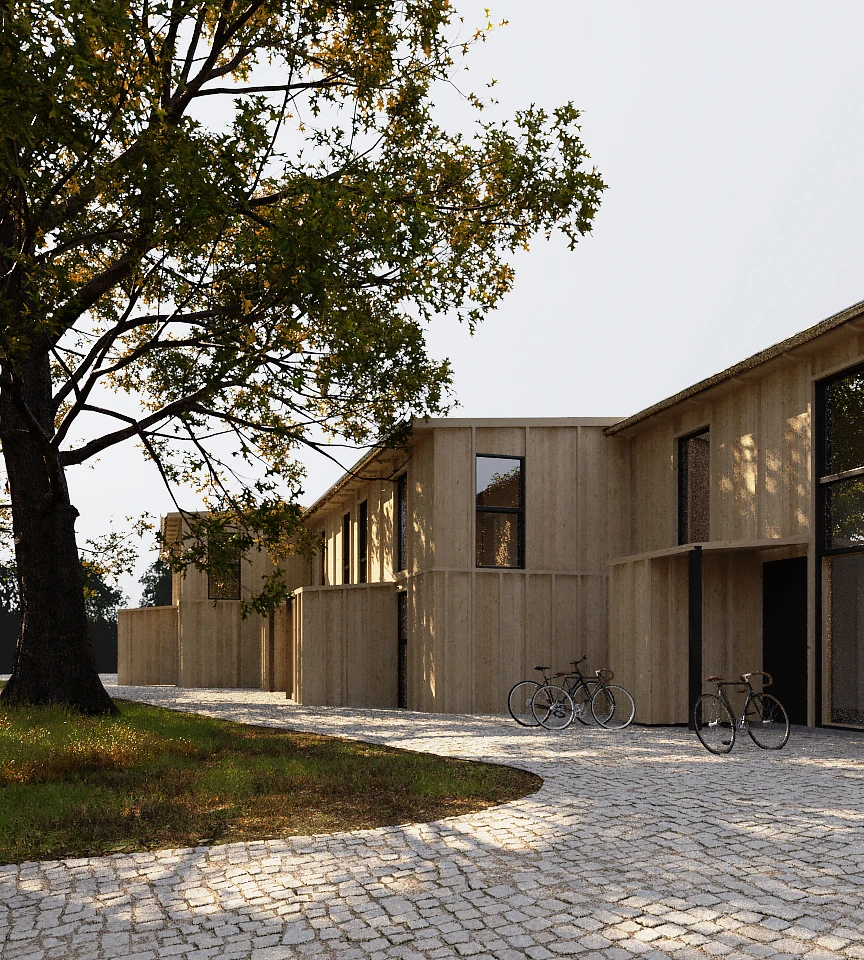 Modern wooden houses with large windows along a curved cobblestone pathway, with three bicycles parked nearby and a large tree with green leaves on the left.