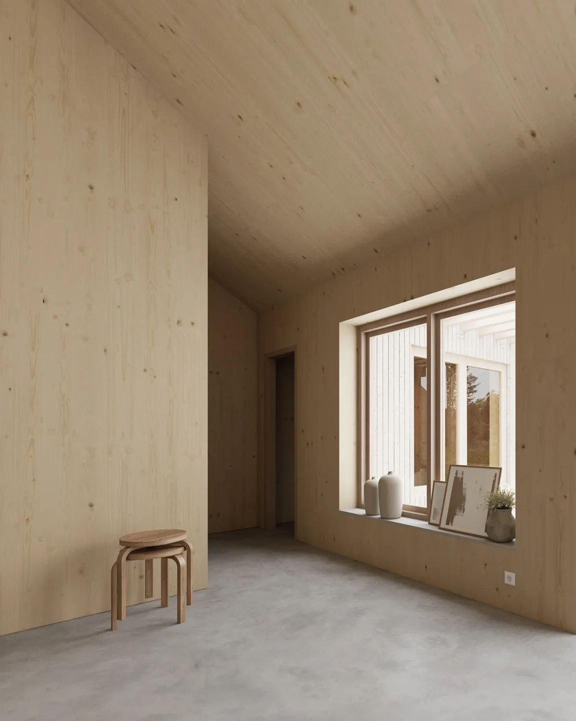 Minimalist room with light wood-paneled walls and ceiling, concrete floor, two stacked wooden stools, and a large window sill holding vases and framed art.