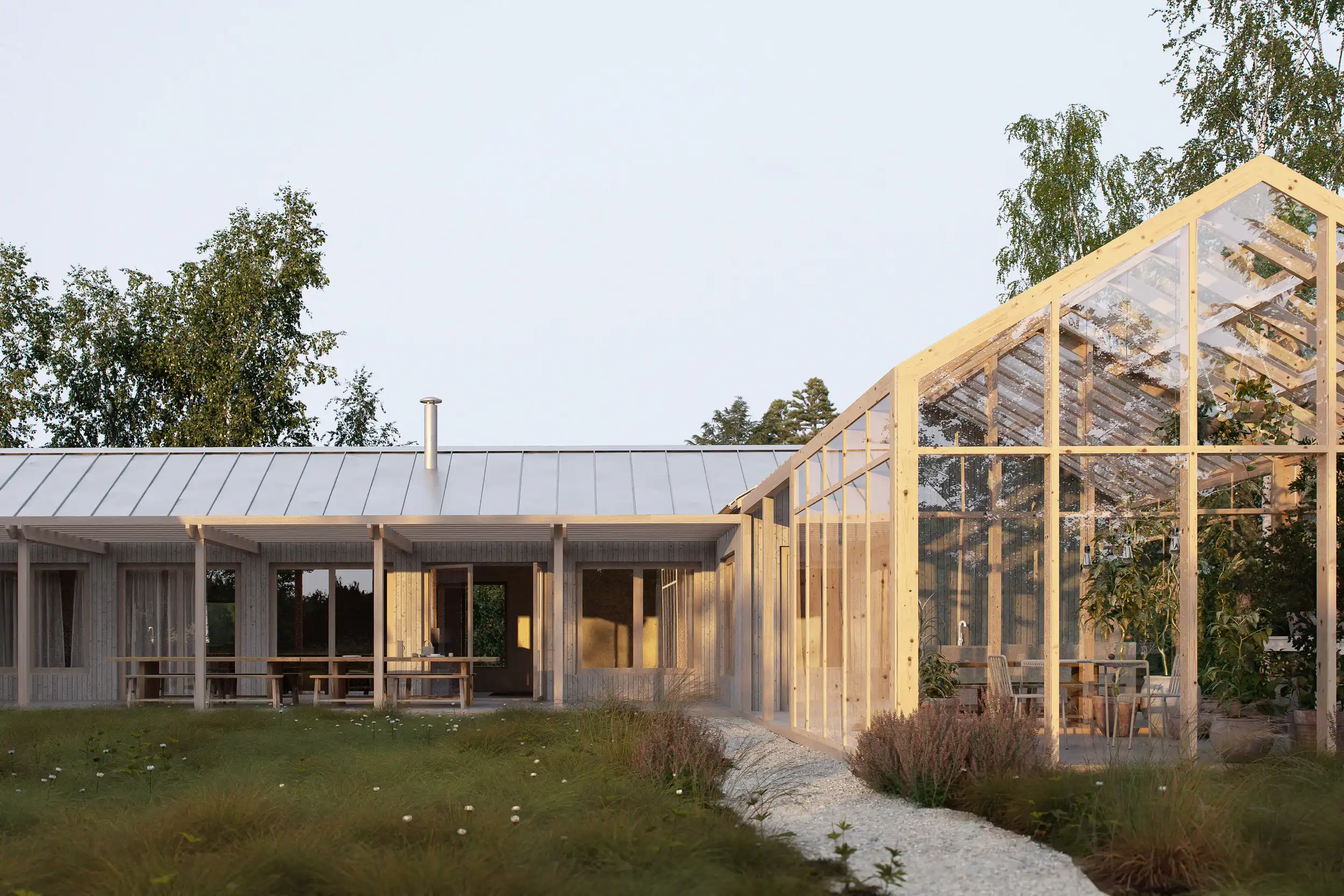 Modern wooden house with a metal roof connected to a glass greenhouse surrounded by grassy landscaping and trees.