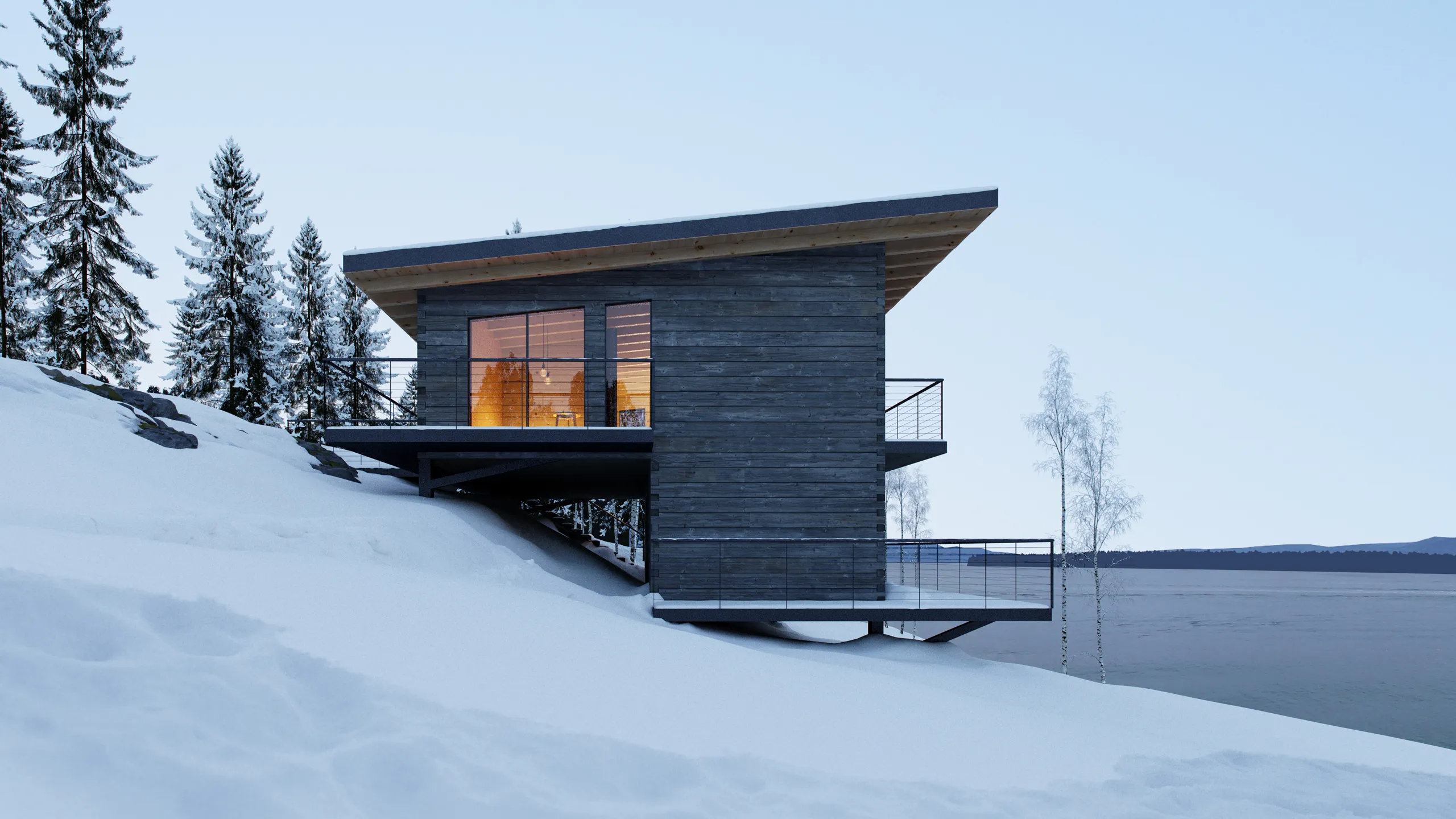 Modern wooden cabin with large glass windows and balcony, situated on a snowy slope overlooking a lake and pine trees.