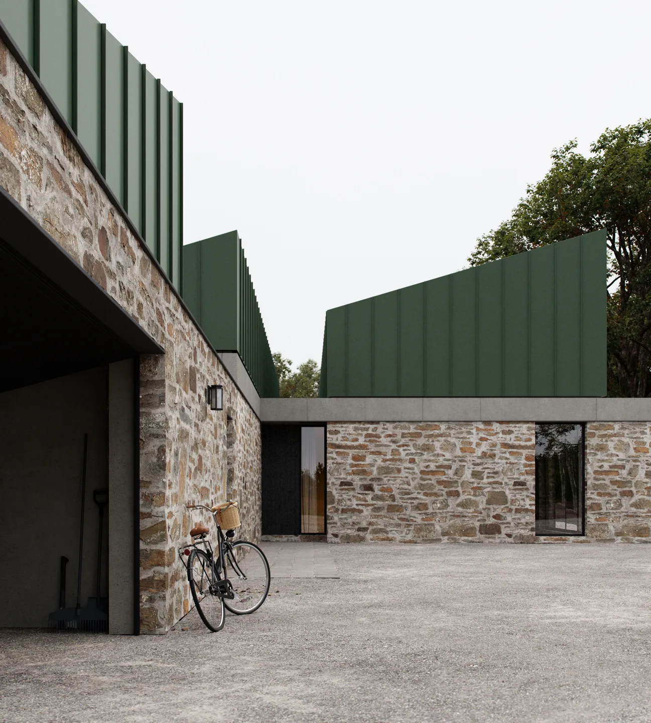 Stone building with green metal panel roofing and a bicycle leaning against the wall near an open garage.
