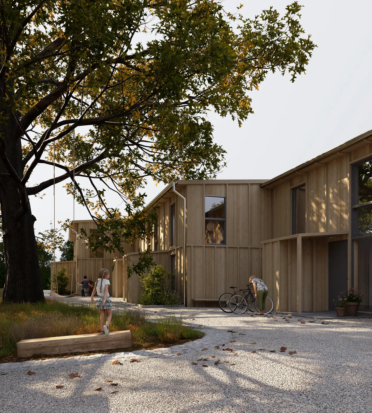 Child walking on a wooden beam with a large tree and swing nearby in a courtyard of modern wooden houses, while another person adjusts a bicycle.