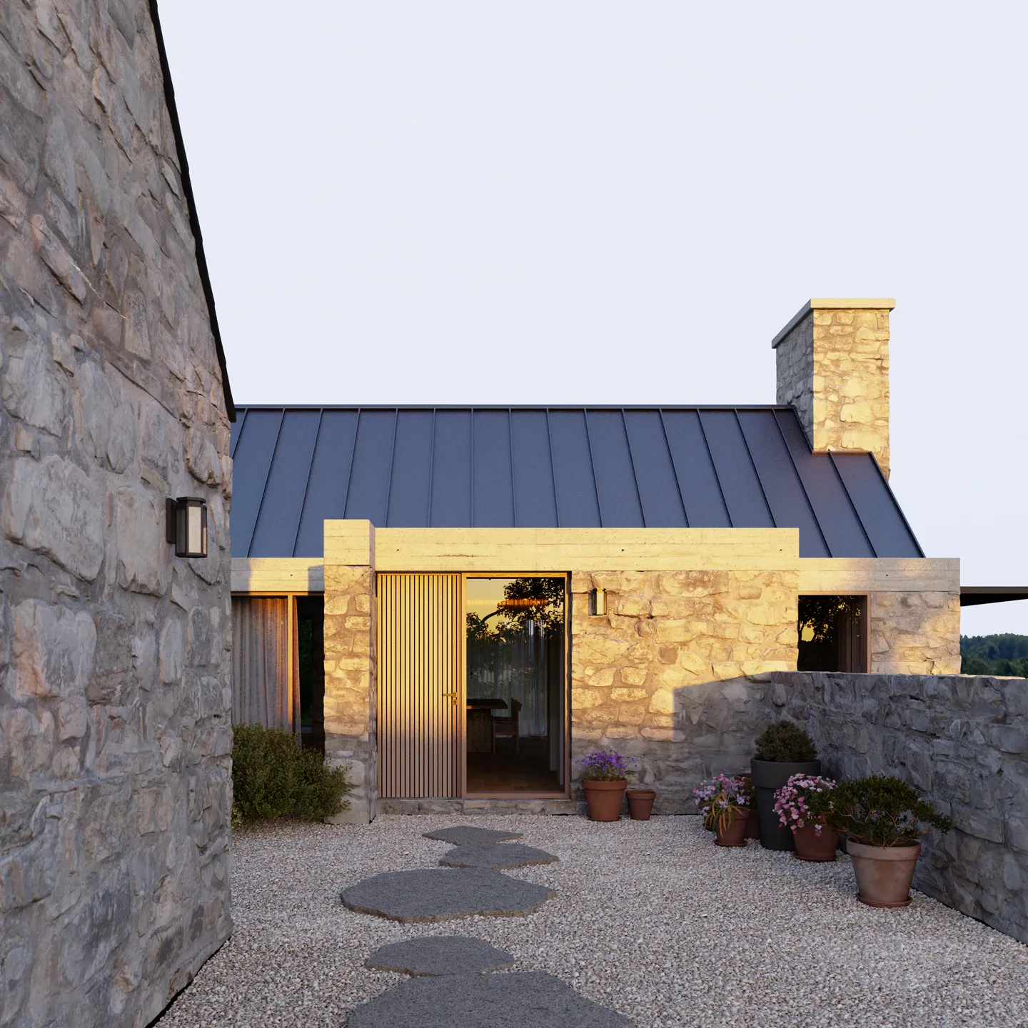 Stone house with a dark metal roof, wooden door, and gravel path lined with potted plants.
