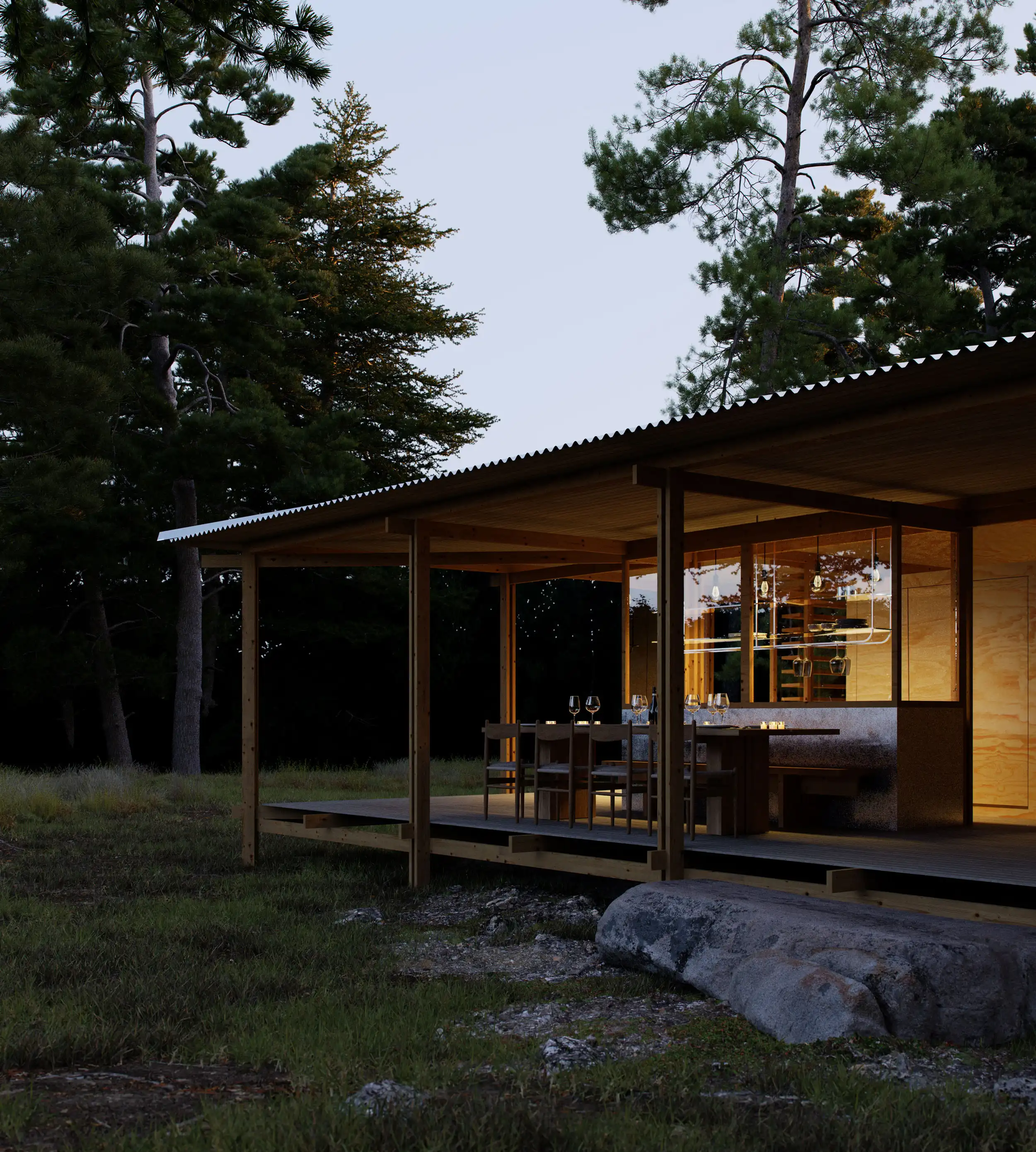 Modern wooden cabin with an illuminated dining area on a covered porch surrounded by trees at dusk.