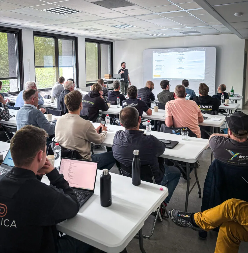 Group of people attentively listening to a presenter who is giving the SmartgridOne Training