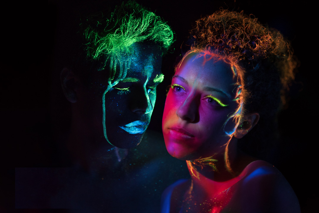 One male and one female models with a forlorn expression with uv light gels applied to them. The project is by Aaron Kho called Nymphs of Iberia.
