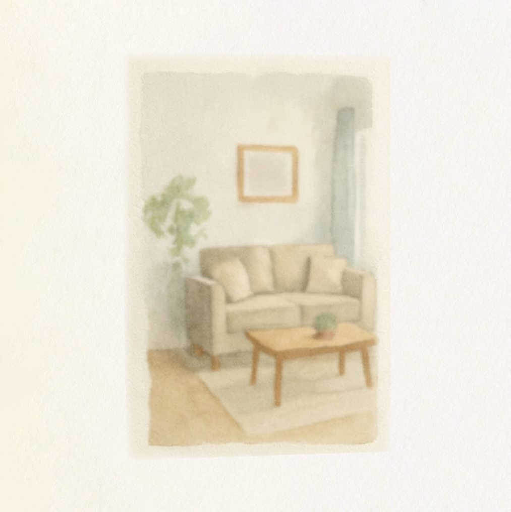 Cozy living room with beige sofa, wooden coffee table, indoor plant, and a framed picture on the wall.