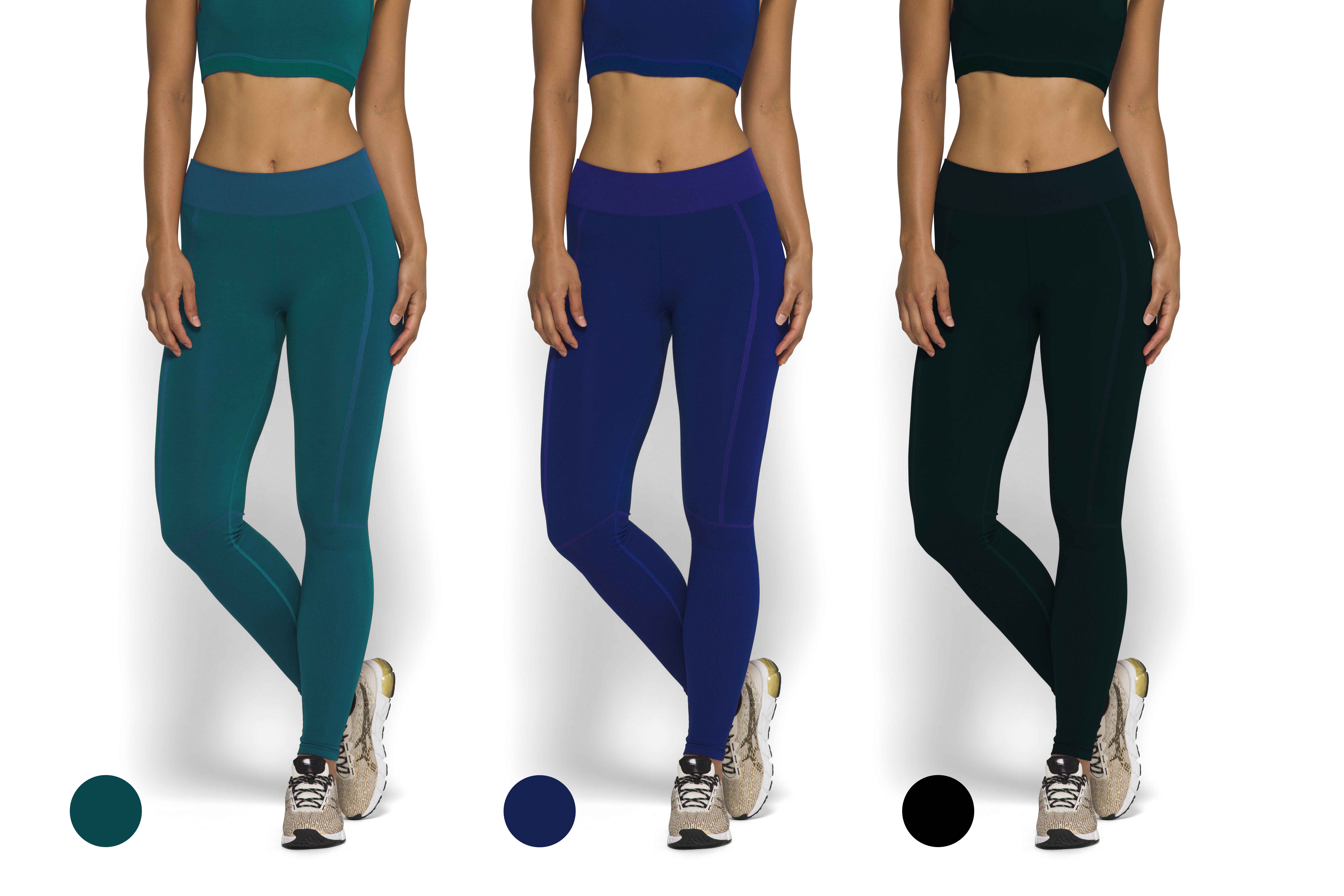 Three women wearing seamless leggings in teal, navy blue, and black, paired with matching crop tops and white running shoes.