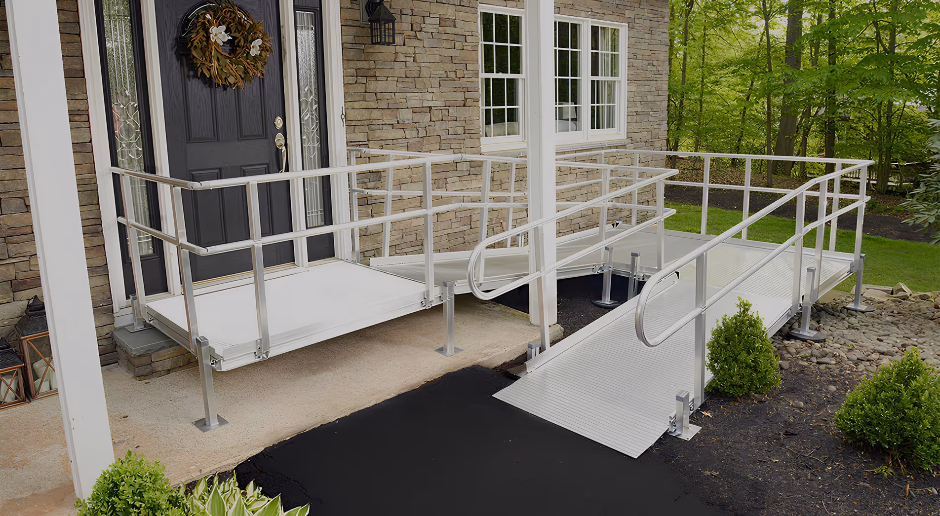 Modular aluminum wheelchair ramp system installed at a home entrance for safe and accessible entry.