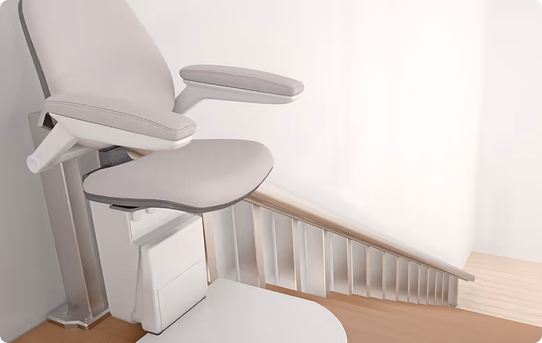 lose-up of a stairlift chair installed on a residential staircase for safe home mobility.