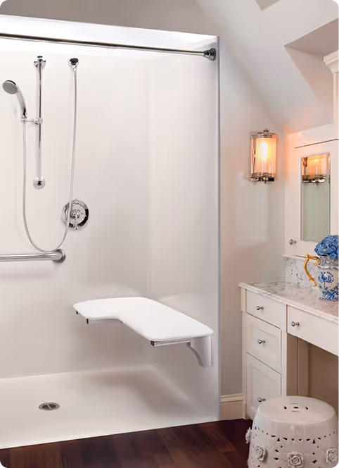 Bathroom walk-in shower featuring a fold-down seat and handheld showerhead for safe bathing accessibility.
