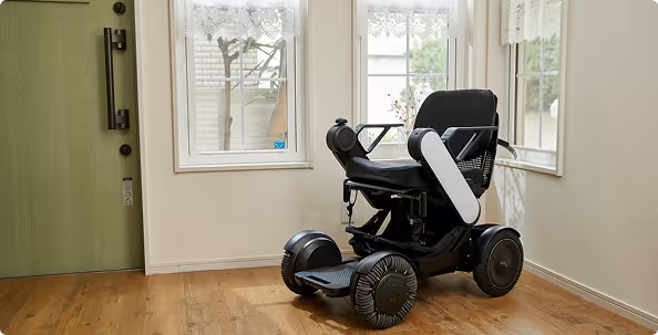 Motorized power wheelchair positioned inside a home to support independent mobility.