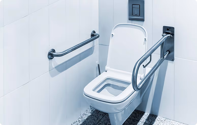 White wall-mounted toilet with open lid and stainless steel grab bars on both sides in an accessible bathroom.