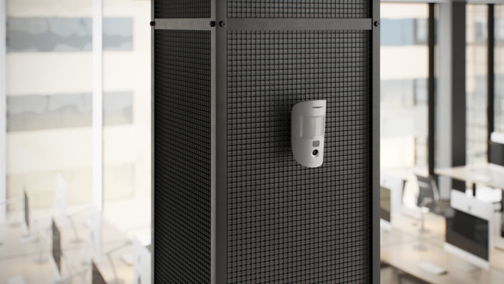 Ajax Systems access control and motion detector installed in a modern office for employee entry management and security