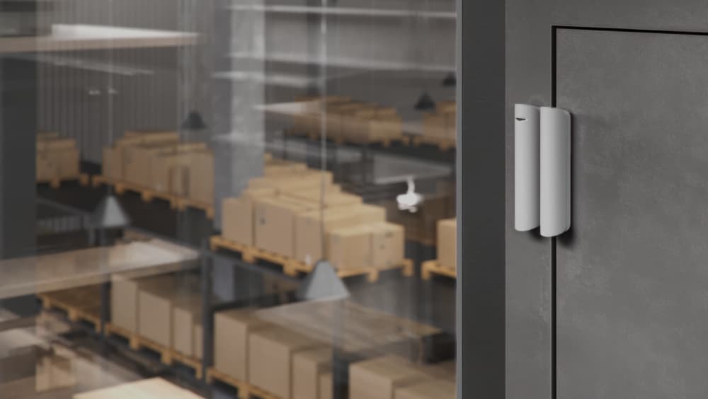 Ajax Systems door sensor installed in a warehouse to protect inventory and industrial storage areas