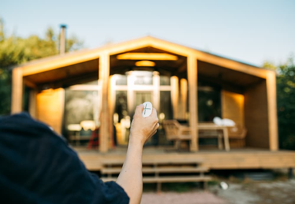Homeowner remotely arming or disarming a home security system from outside the house
